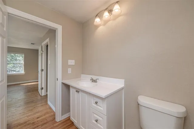 a view of a bathroom with a toilet sink and mirror