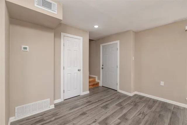 a view of hallway with wooden floor
