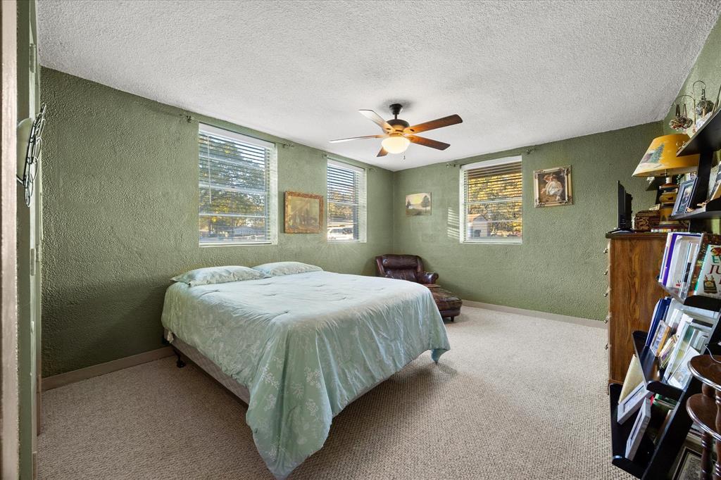 2097 County Road 3830 Quinlan, TX 75474 - Photo 18 of 38 a bedroom with a bed and a flat screen tv