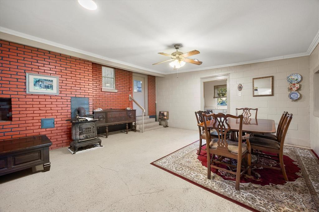 2097 County Road 3830 Quinlan, TX 75474 - Photo 22 of 38 a living room with furniture and a chandelier