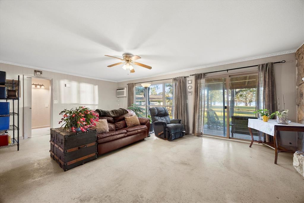 2097 County Road 3830 Quinlan, TX 75474 - Photo 23 of 38 a living room with furniture and large windows
