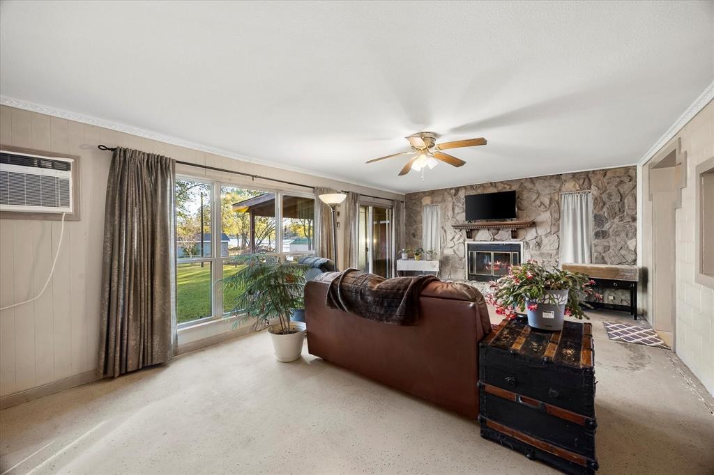 2097 County Road 3830 Quinlan, TX 75474 - Photo 24 of 38 a living room with furniture fireplace and flat screen tv