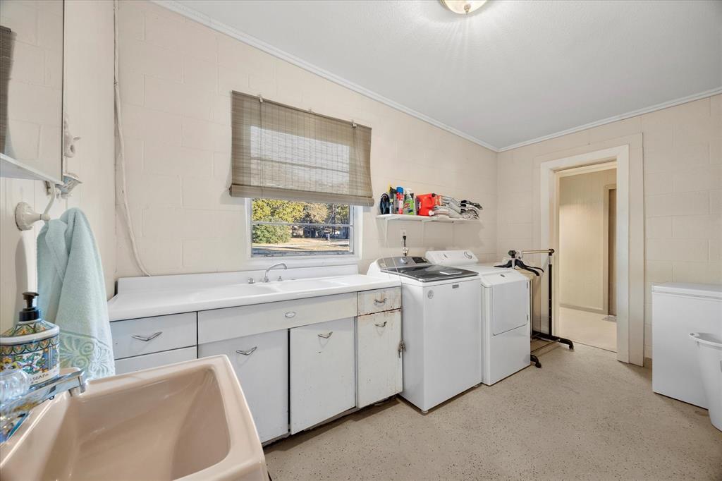2097 County Road 3830 Quinlan, TX 75474 - Photo 25 of 38 a utility room with cabinets dryer and washer