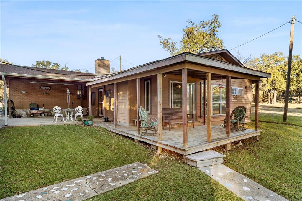 2097 County Road 3830 Quinlan, TX 75474 - Photo 30 of 38 a view of a house with a yard
