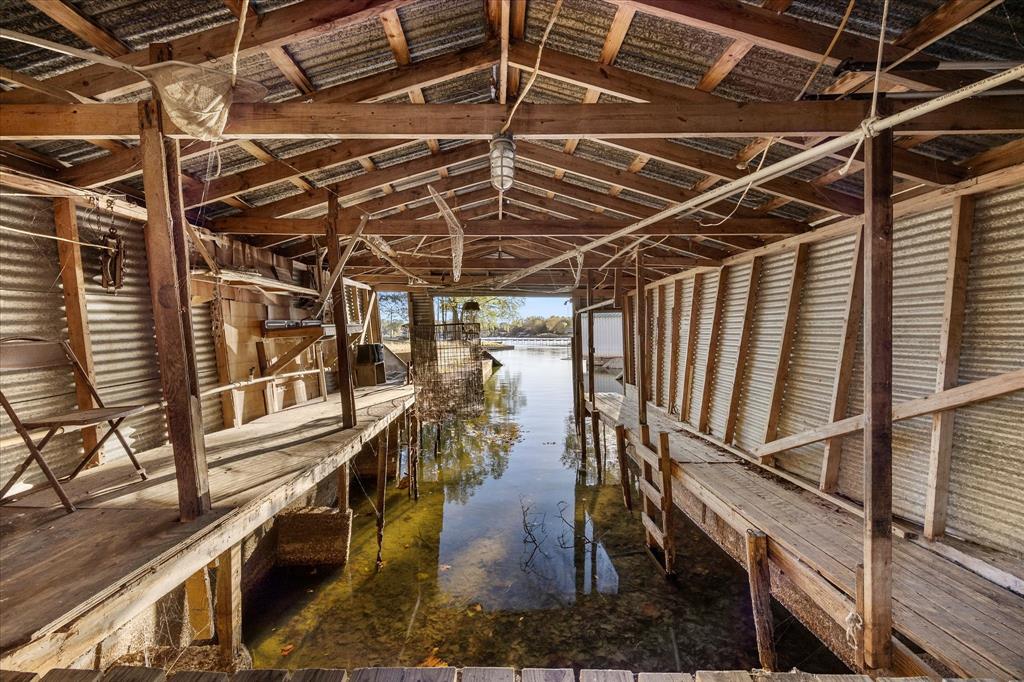 2097 County Road 3830 Quinlan, TX 75474 - Photo 33 of 38 a view of an empty room with wooden floor