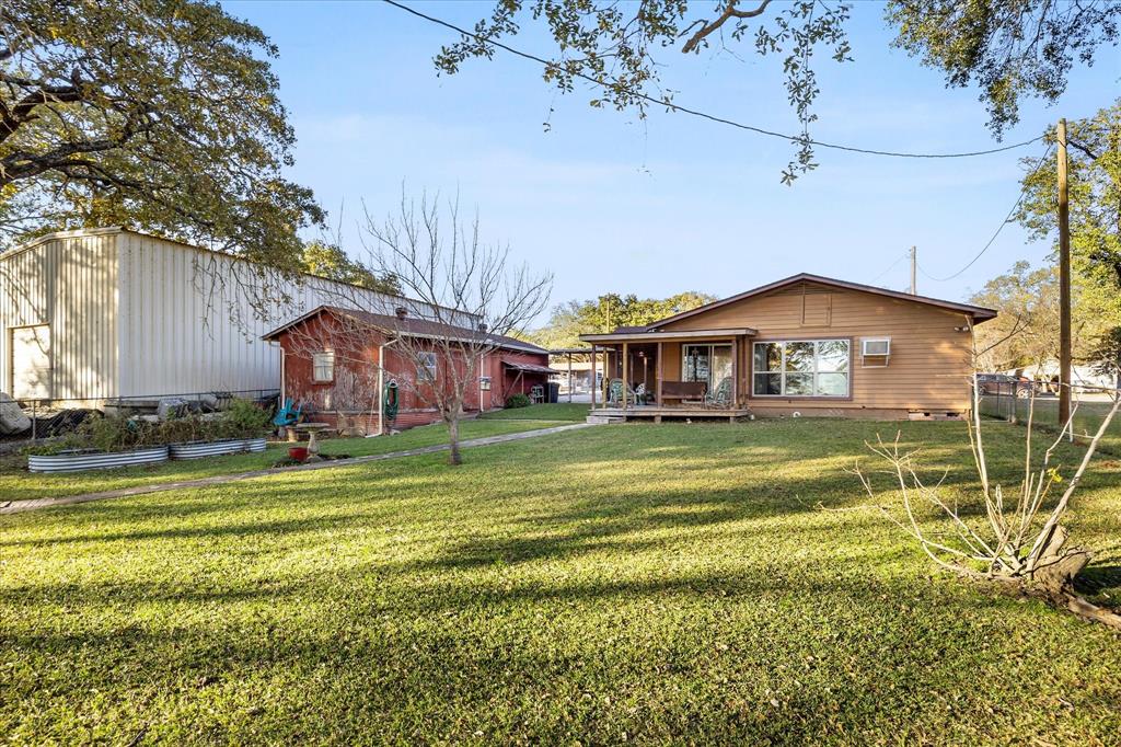2097 County Road 3830 Quinlan, TX 75474 - Photo 34 of 38 a front view of a house with a yard table and chairs