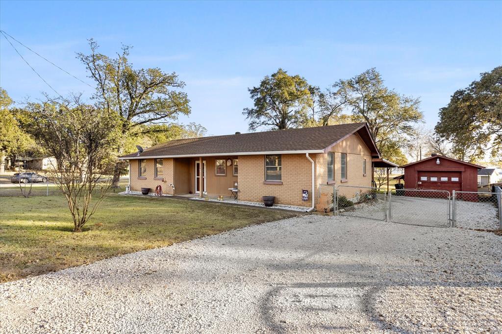 2097 County Road 3830 Quinlan, TX 75474 - Photo 4 of 38 a front view of a house with a yard and garage