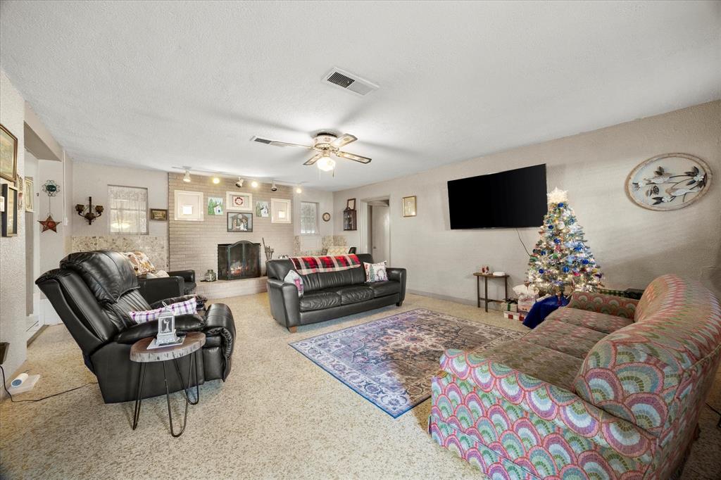 2097 County Road 3830 Quinlan, TX 75474 - Photo 5 of 38 a living room with furniture and a flat screen tv