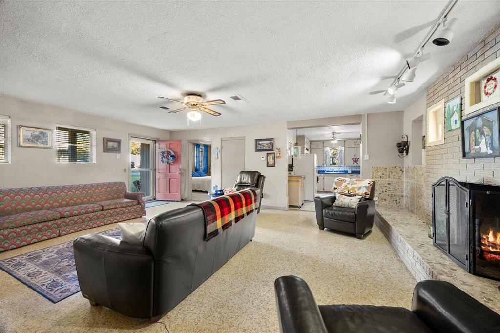2097 County Road 3830 Quinlan, TX 75474 - Photo 6 of 38 a living room with furniture and a flat screen tv