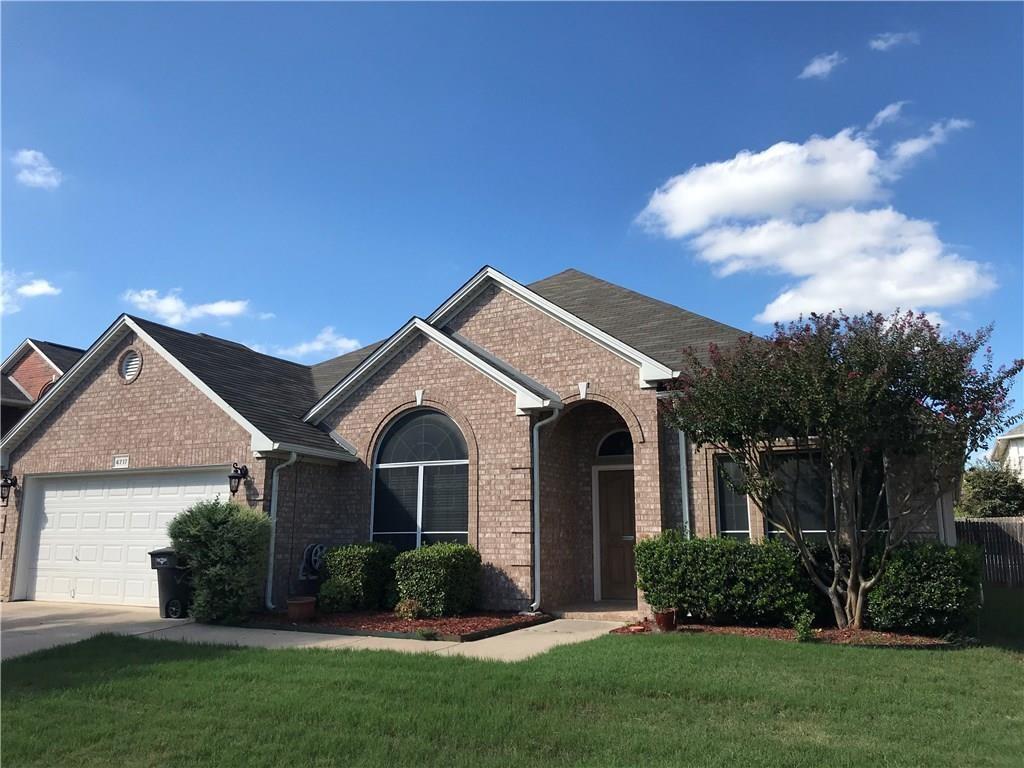 a front view of a house with a garden and plants