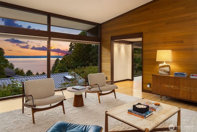 a living room with furniture and a floor to ceiling window
