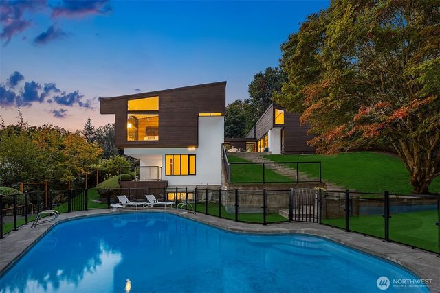 a view of a house with backyard and sitting area