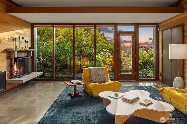 a living room with furniture and a floor to ceiling window