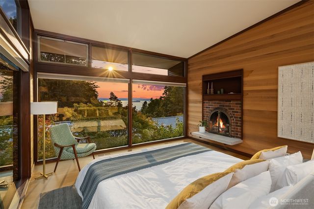 a bedroom with a bed and a balcony view