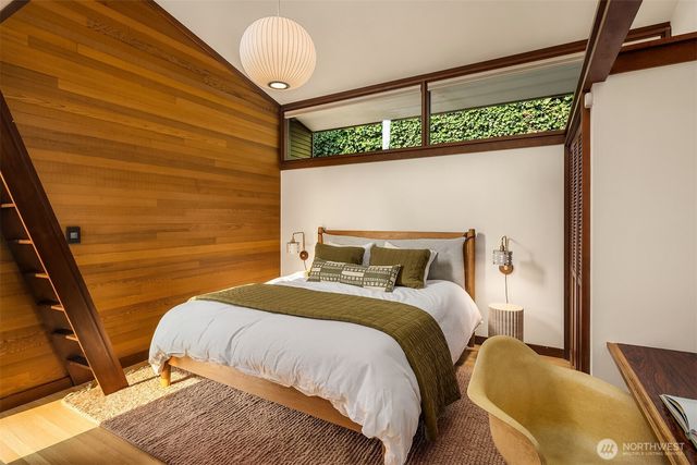 a bedroom with a bed and a window