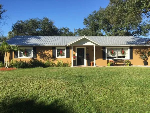 a front view of a house with a yard table and chairs