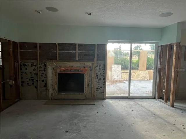 a view of an empty room with a fireplace