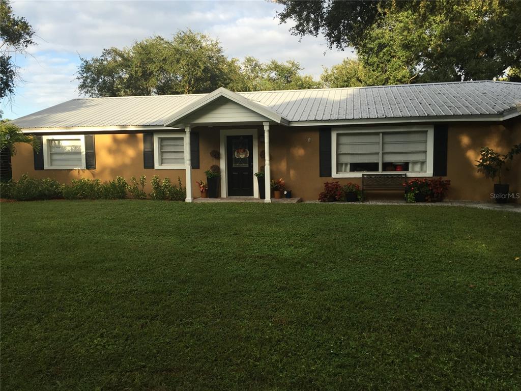 8823 Oak Street Riverview, FL 33578 - Photo 2 of 23 a front view of a house with a garden