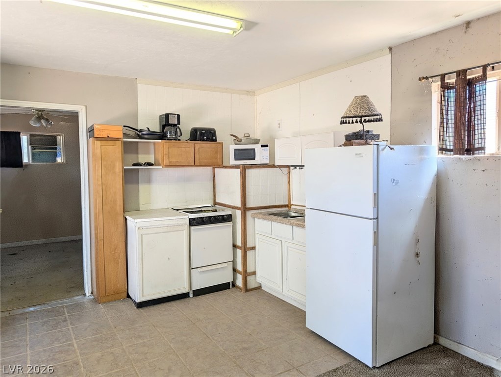 997 Phillips Street Panaca, NV 89042 - Photo 17 of 19 Casita-A compact kitchen with simple cabinetry and essential appliances offers functional living.
