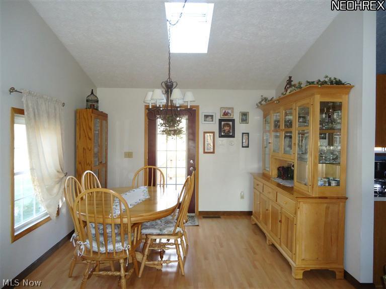 4315 Mayfair Road Uniontown, OH 44685 - Photo 6 of 25 Dining area with laminate floors and patio door opens to large back yard and rear deck.