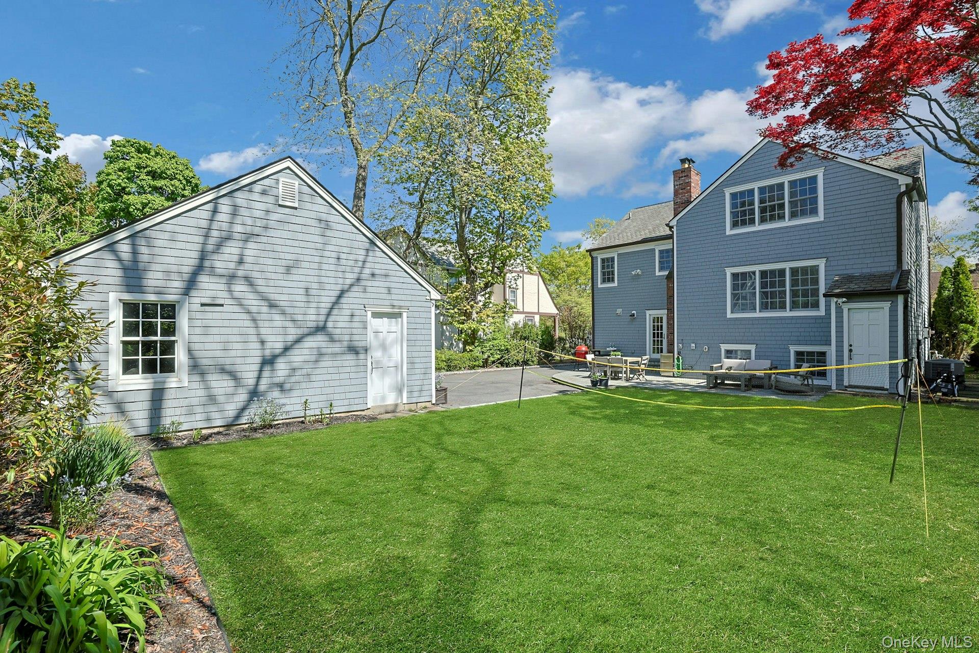 33 Lawrence Road Scarsdale, NY 10583 - Photo 4 of 8 Expansive, level grounds provide a wonderful backdrop for outdoor enjoyment, surrounded by mature landscaping.