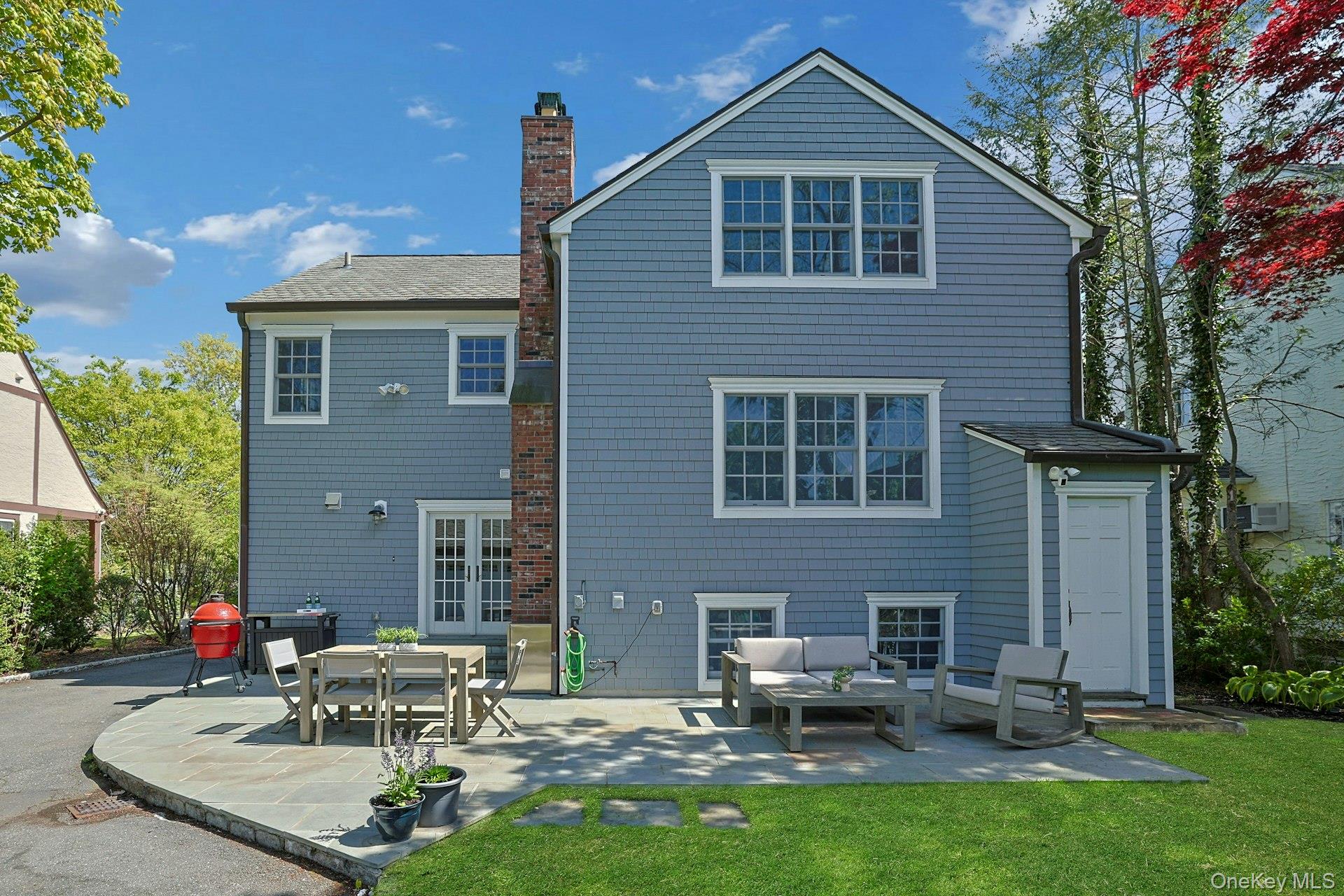 33 Lawrence Road Scarsdale, NY 10583 - Photo 5 of 8 The home’s rear façade highlights its classic architecture and effortless connection to the outdoor entertaining spaces.
