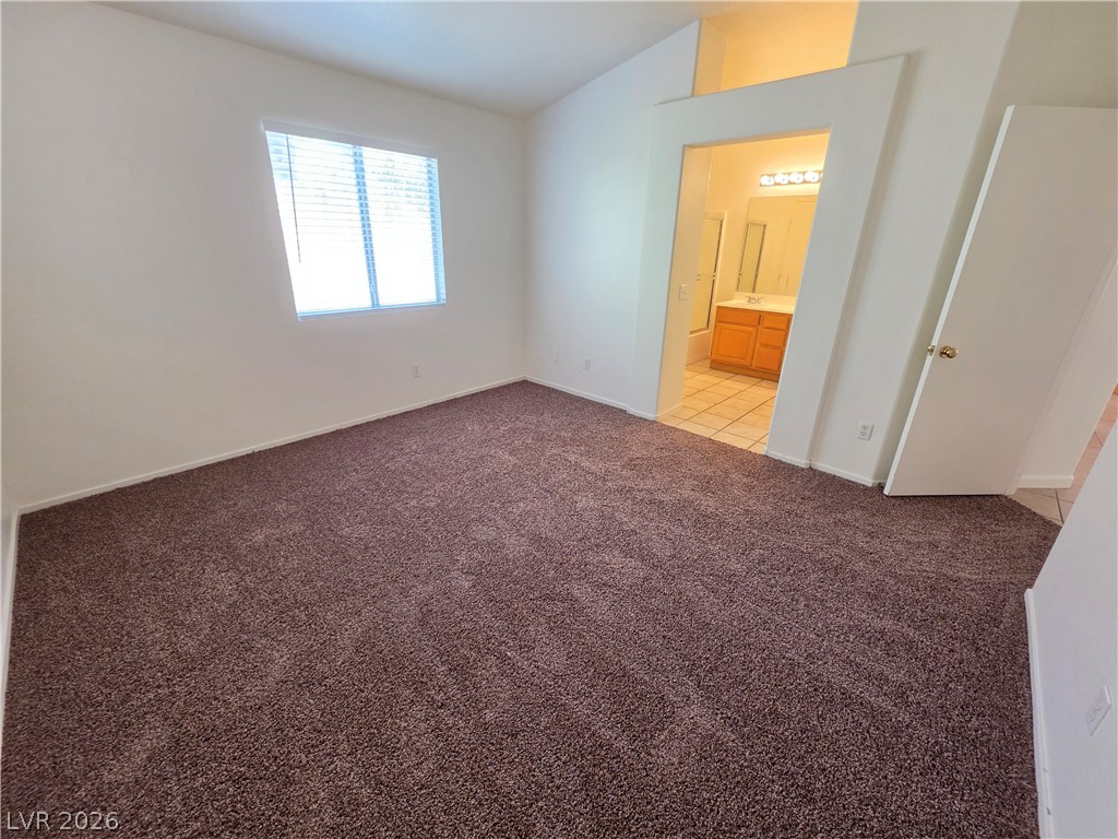 9609 Crystal Ridge Road Las Vegas, NV 89123 - Photo 16 of 21 Vaulted ceilings and plush carpeting define this comfortable primary suite with an attached bath.