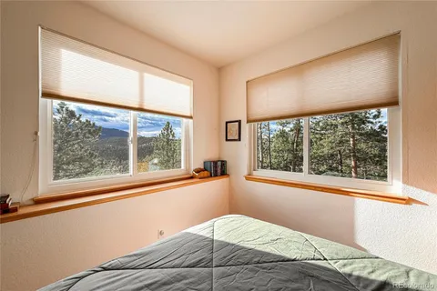 a bedroom with a large bed and a large window