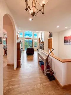 a view of a room with wooden floor and furniture