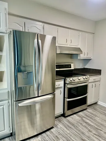 a stove top oven sitting inside of a kitchen
