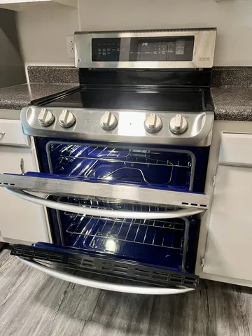a stove top oven sitting inside of a kitchen