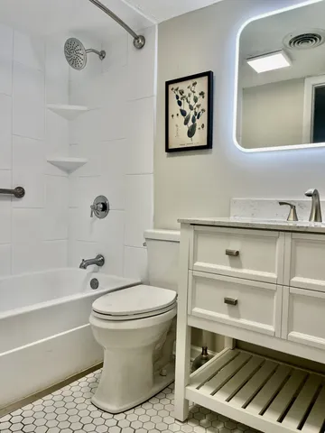 a bathroom with a toilet a sink and bathtub