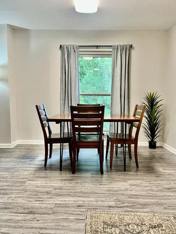 a view of a dining room with furniture and wooden floor