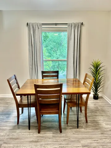 a view of a dining room with furniture window and wooden floor
