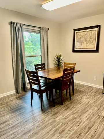a view of a dining room with furniture and wooden floor