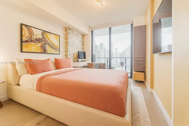 a bedroom with a large bed and a large window