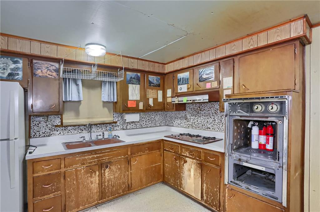 516 17th Street Beaver Falls, PA 15010 - Photo 11 of 28 a kitchen with stainless steel appliances granite countertop a sink and cabinets