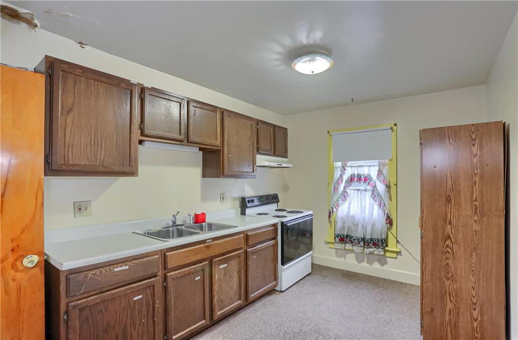 516 17th Street Beaver Falls, PA 15010 - Photo 21 of 28 a kitchen with granite countertop a sink stainless steel appliances a counter space and cabinets