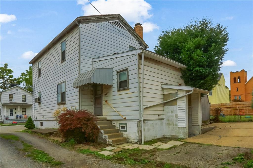 516 17th Street Beaver Falls, PA 15010 - Photo 3 of 28 a front view of a house with a yard