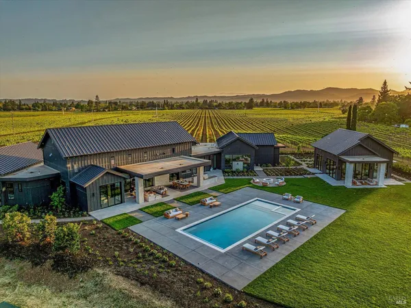 a view of a house with pool garden and lake view