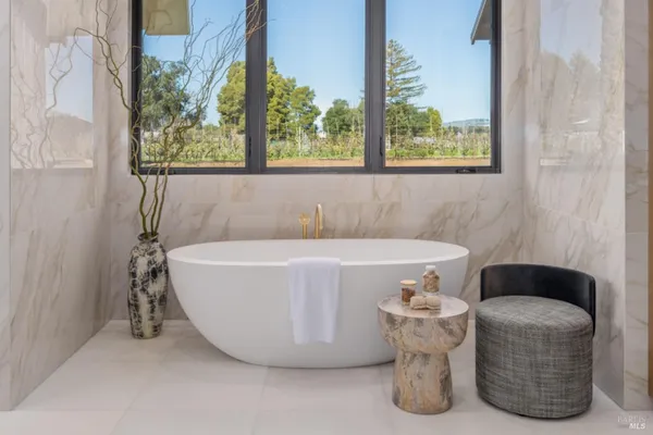 a spacious bathroom with a granite countertop sink and a mirror