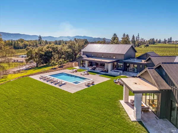 a view of house and outdoor space with swimming pool and furniture