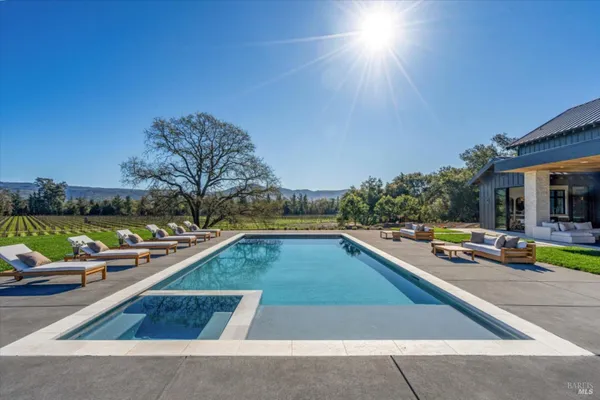 a view of swimming pool with chairs