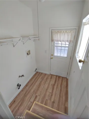a view of room with window and hardwood floor