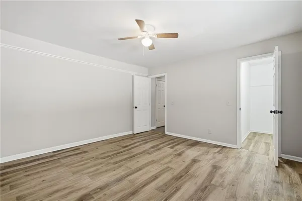 a view of an empty room with wooden floor