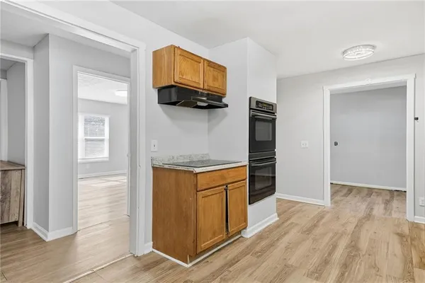a kitchen with stainless steel appliances granite countertop a refrigerator and a stove top oven