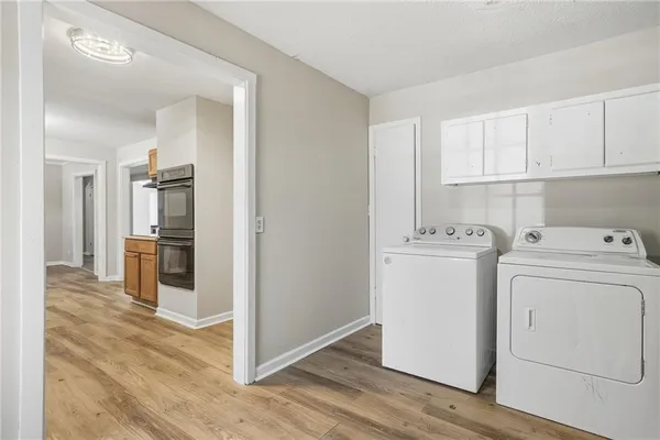 a view of a kitchen with refrigerator and cabinets
