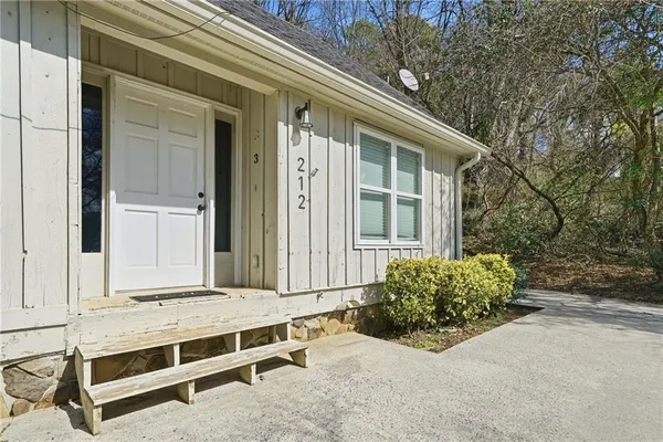 a view of backyard with large window and wooden fence