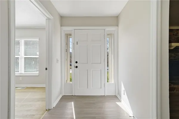 a view of an empty room with wooden door