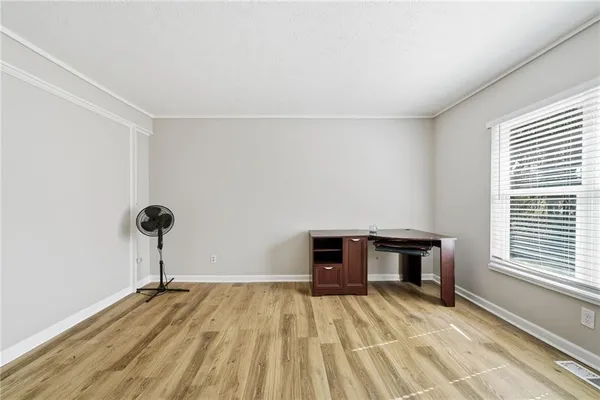 a view of empty room with a window and a ceiling fan